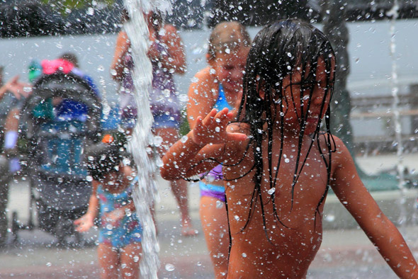 Kids playing in spray fountains on the Greenway