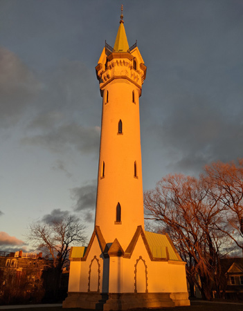 Orange Fort Hill water tower at sunset