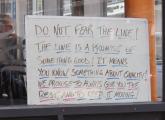 Sign at Figaro's in the Leather District that says to embrace the line