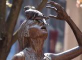 Pigeon on Irish Famine Memorial woman in Downtown Crossing