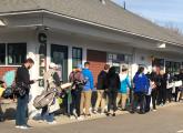 People waiting to hit golf balls in Dedham