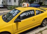 Abandoned car with a tiger head on it