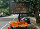 Sign board reading: Utility work ahead how bout dat